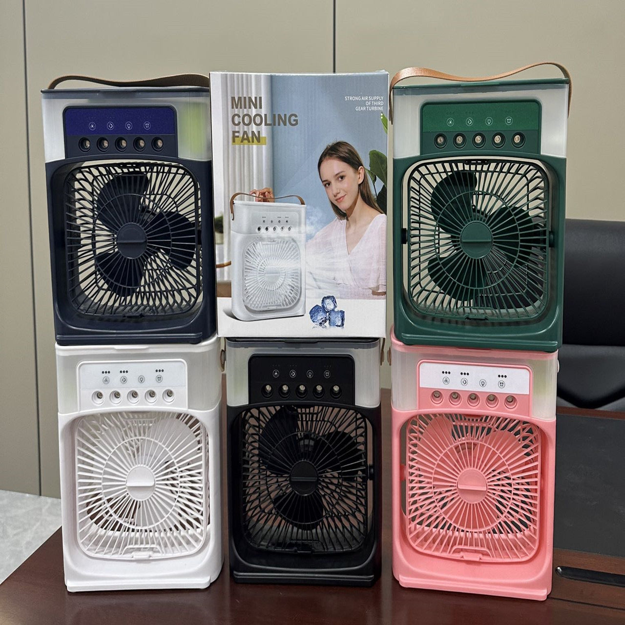 Portable air cooler fan in various colors with user manual, showcasing compact design and cooling features.